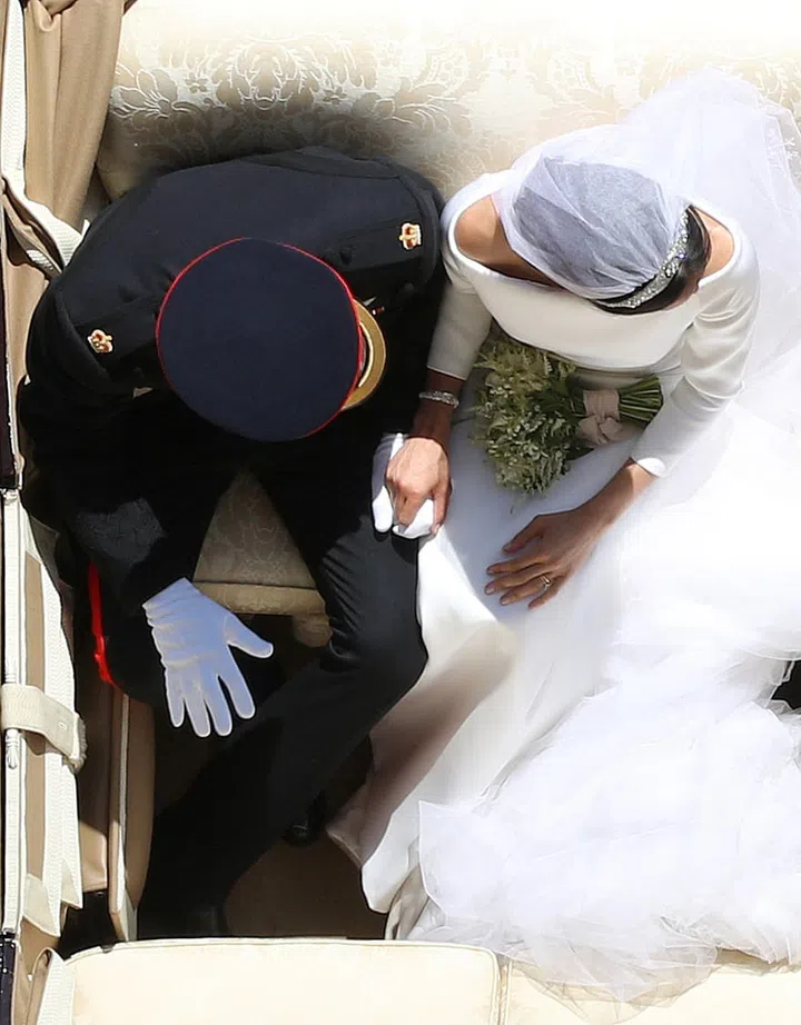 Prince Harry and his wife Meghan, Duchess of Sussex ride in the Ascot Landau Carriage as they pass through the Cambridge Gate 