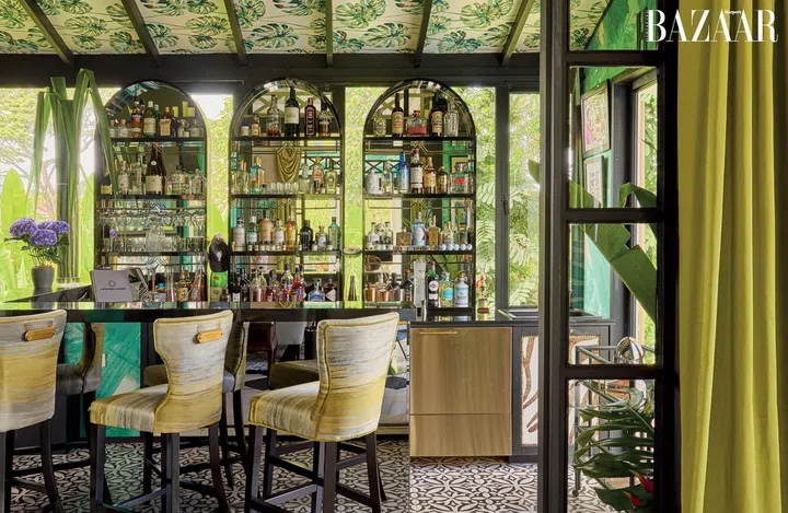 The bar is set against a backdrop of verdant greenery.