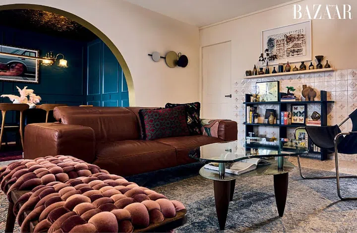 The living room’s artful mix of furniture includes a velvet bench from Knots Studio, a leather couch from Prestige Affairs and a salvaged table bought online.