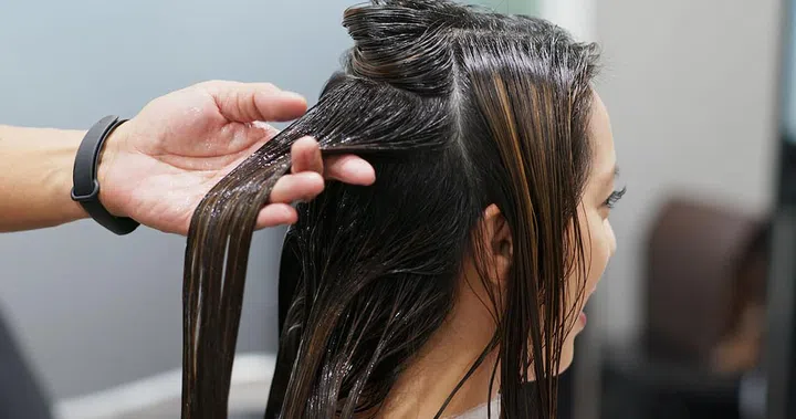 Woman having hair treatment in hair salon