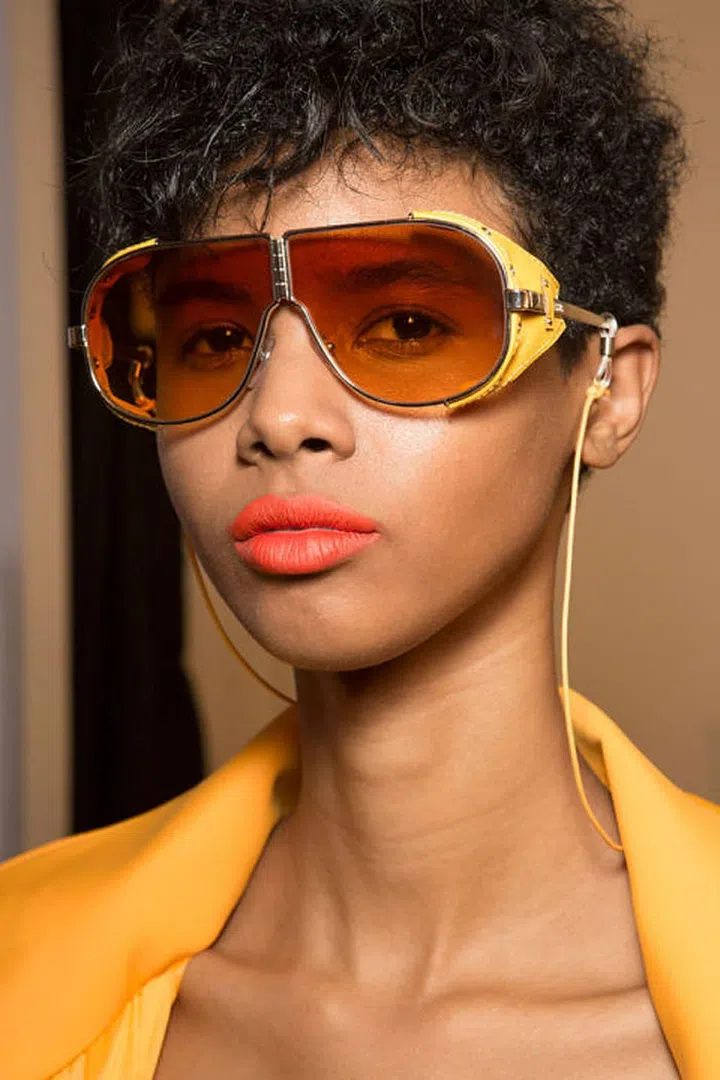 A peachy orange lipstick to coordinate with the collection backstage at Versus.