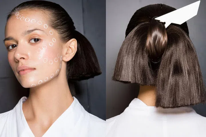 The Look: Geometry Play
How-To: The Issey Miyake show is one you can always count on to push creative boundaries with clothing and beauty. So while these geometric face circles created by makeup artist Alex Box might not be totally wearable, we love them for their sheer inventiveness. Box called the rings "impactful but delicate," and she created each one by dipping white pigment in a pencil topper and stamping it along the contours of the face. Hairstylist James Pecis took the same idea to the hair with an asymmetrical looped ponytail accessorized with a geometric shape. Out-of-the-box beauty looks can sometimes be more intellectual than beautiful, but the look at Issey Miyake happened to be both. 