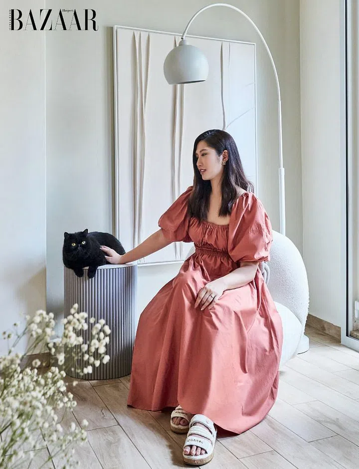 Wong, in her own Acler dress, Chanel sandals and earring, and ring, having a quiet moment with Boba.