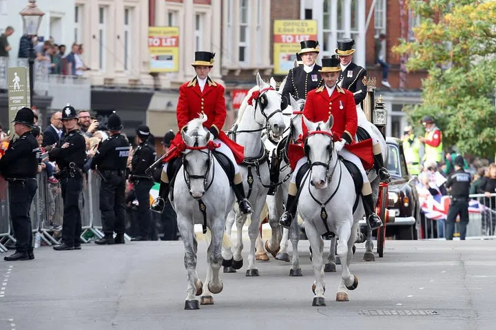 The horse drawn carriage drove the newlyweds through the streets.