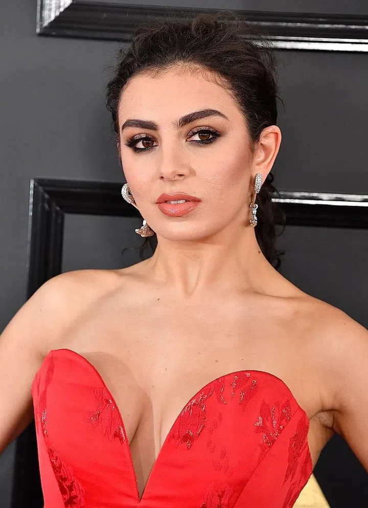Charli was giving us Jessica Rabbit realness from head to toe. Her 90s inspired nude lip is created by lining her entire lip with Make Up For Ever's Aqua Lip Pencil in 4C and Make Up For Ever Artist Rouge Creme in C105 on top. To add shine and hydration, her makeup artist, Colby Smith, applied Kiehl's Lip Balm in #1 at the every end. Photo: Getty
