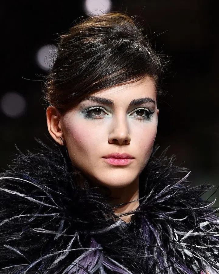 Teased, combed to one side, and secured loosely with pins—the hair at Armani looked like a retro, '60s hairstyle that had hit the party circuit the night before.