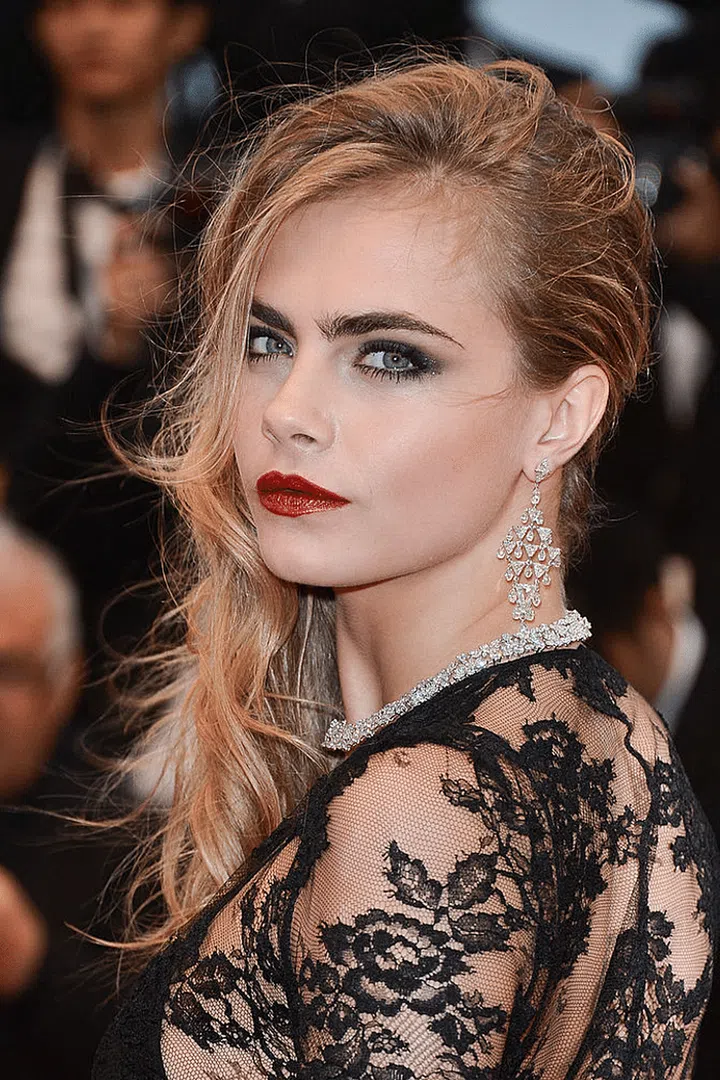 Looking like a queen in blood red lips and dark eyes.