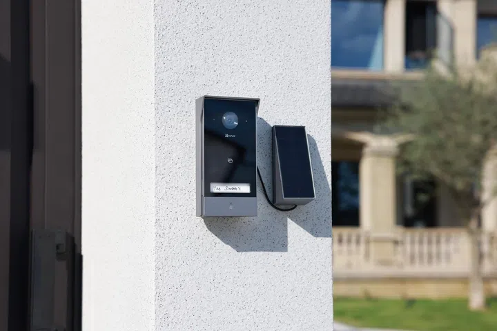 ezviz ep7 smart video doorphone mounted beside a solar panel on an exterior wall