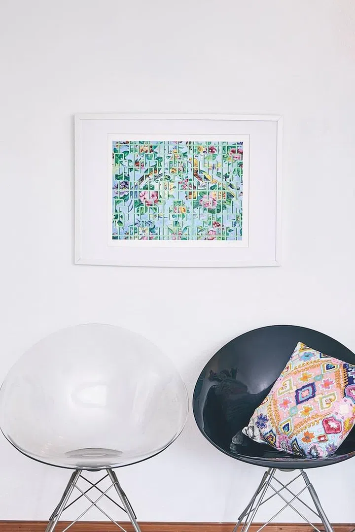 A colourful Pierre Frey cushion and artwork by Julie Williams liven up minimalist Ero|S| chairs designed by Philippe Starck for Kartell. (Photo: Veronica Tay)