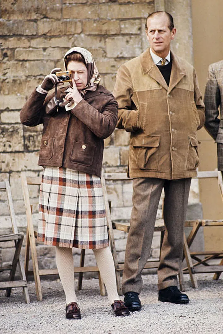 A plaid skirt, jacket and head scarf is Queen Elizabeth II's go-to casual outfit. Here she is in 1973 with her husband Prince Philip at the Badminton Horse Trials.