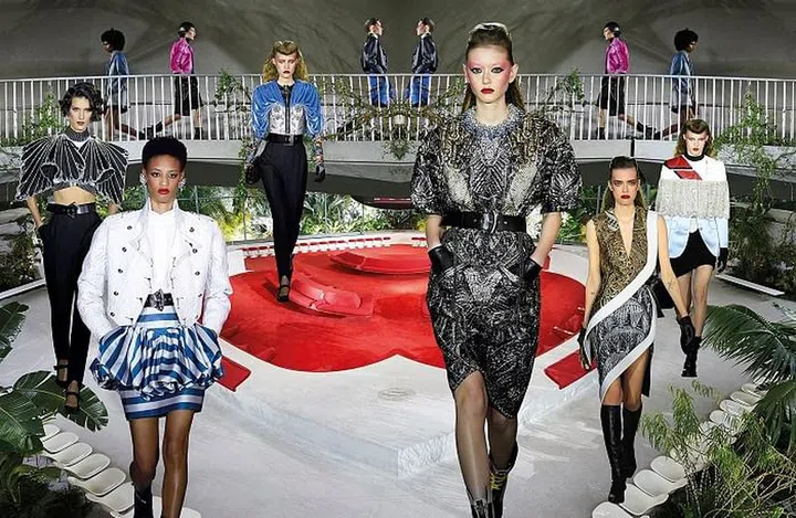 Nicolas Ghesquière based his collection on a foreigner’s fantasy of New York City and, fittingly, staged his show at the recently restored TWA Flight Center—an architectural marvel designed by Eero Saarinen in 1962 that was a fine backdrop for his retro-futuristic outing. With the city skyline emblazoned on berry-coloured jackets, the famed Chrysler Building embroidered on metallic tops, and pinstriped suiting and workwear fit for Wall Street, the clothes were an ode to NYC. There was also plenty of inky black leather, superbly crafted into slick coats, minidresses, turtlenecks and full-length gloves, with some looks veering into superhero territory. New York did, after all, inspire the fictional cities of Gotham and Metropolis. The era-defying, space-party aesthetic that has become a trademark of the House under Ghesquière was present—think ’80s bubble skirts, fiercely embellished geometric tops and plush velvet—but the designer took his fascination with all things tech a step further with futuristic prototypes of classic LV bags, which flaunted new flexible screens wrapped around their bodies. Taken in all at once, it was a glitzy, flamboyant, nearly overpowering affair, much like the city in question.