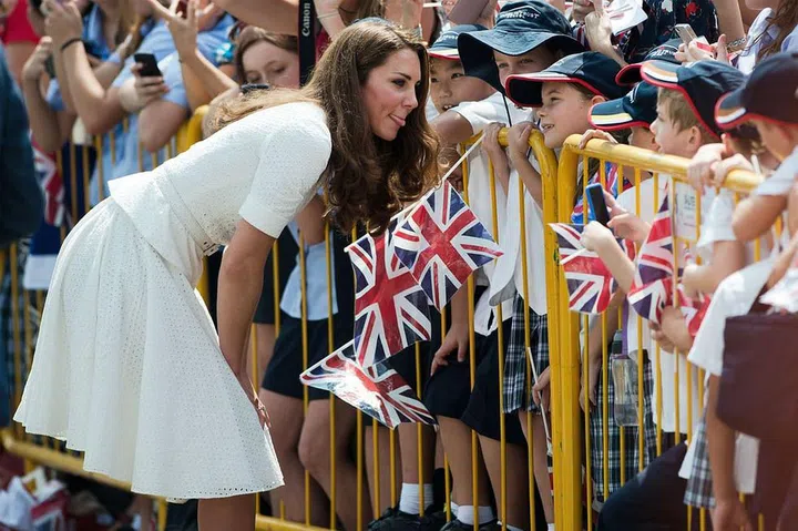 A playful Duchess of Cambridge sticks her tongue out at young fans greeting her at Gardens by the Bay during her visit to Singapore. Photo: Getty
