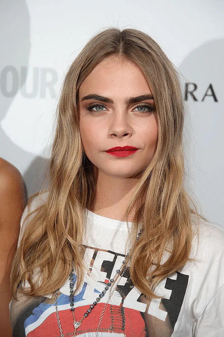 She doesn't need dewy skin to look fresh in this matte complexion and red lips.