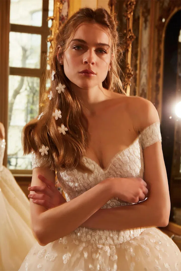 A classic half-up wavy hairstyle could use a little more than a sparkly pin and veil to look fresh and new. At Elie Saab, white flowers were glued along the length of the hair for one of the most romantic and fun hair looks of the season.