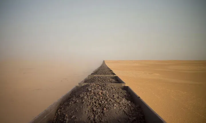 To capture this image, Guerin had to stand on the rocks for height and position himself in a rear carriage to get the full view of the 2.5km long, iron-ore train. 