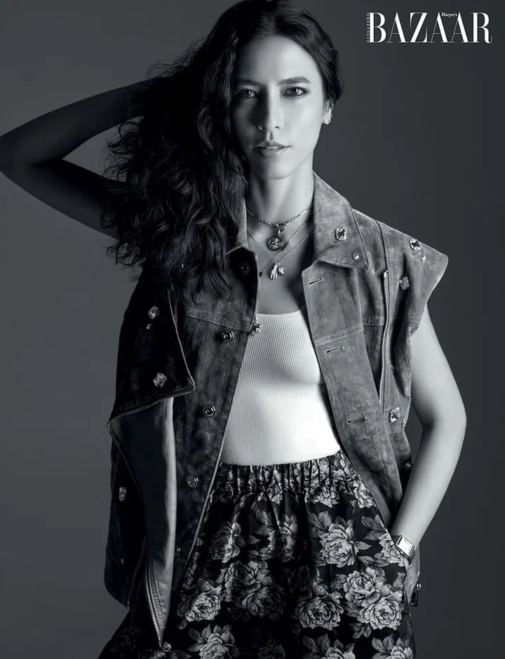 Vest, MCM. SKIMS top; GANNI skirt; Cartier watch and vintage jewellery, her own