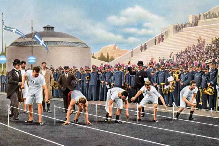 On your mark, get set, go: The 100 meters sprint race at the game in Athens. Comfortable sportswear is now de rigueur for both female and male track and field athletes, seen here in loose shorts and fitted vests. Jersey cotton and silk tops and trousers, tracksuits, and off-duty sports blazers become the norm, a departure from the hot wool suits that athletes wore in prior decades. Photo: Getty