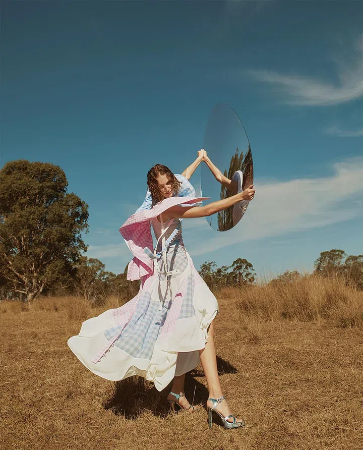 Cotton dress, Loewe. 
Leather sandals, Gucci
