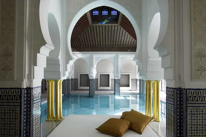 Hidden within the walls of the legendary 17-acre royal gardens, the world-renowned La Mamounia in Marrakech offers a 7,500-square-foot outdoor swimming pool. Guests will find poolside shade from the Moroccan sun under a canopy of 700-year-old olive trees, and a grove of amaranth agaves, and periwinkle of Madagascar. The water in the pool is treated with non-irritating ozone instead of chlorine, suffusing the gardens and grounds with a just-after-the-rainstorm fragrance. If lounging in the sun isn't your thing, find solace from the heat at the indoor pool nestled between marble columns and intimate day beds.