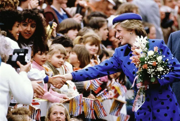 In a black and blue polka dot suit while greeting people on a royal trip to Canada. Photo: Getty