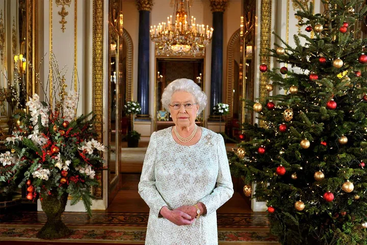 In this photo from her 2012 Christmas address, we can get a great look at the holiday decorations at Buckingham Palace, from the fabulous floral arrangements to the red-and-gold decorated tree.