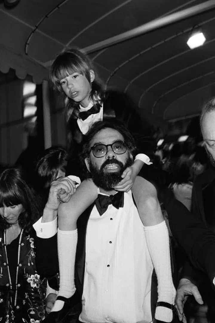 This is Sofia Coppola wearing a baby tux on the shoulders of her dad. Adorable. Photo: Getty