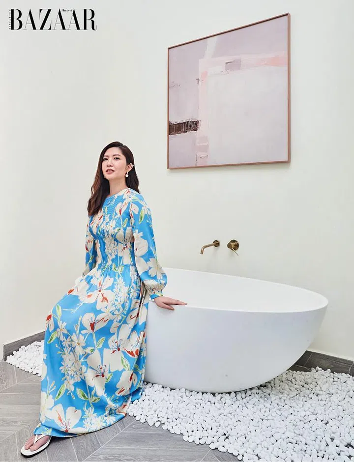 Wong, dressed in a billowy Loro Piana dress, Tory Burch sandals, and her own Van Cleef & Arpels earrings and necklace, on her bathtub.