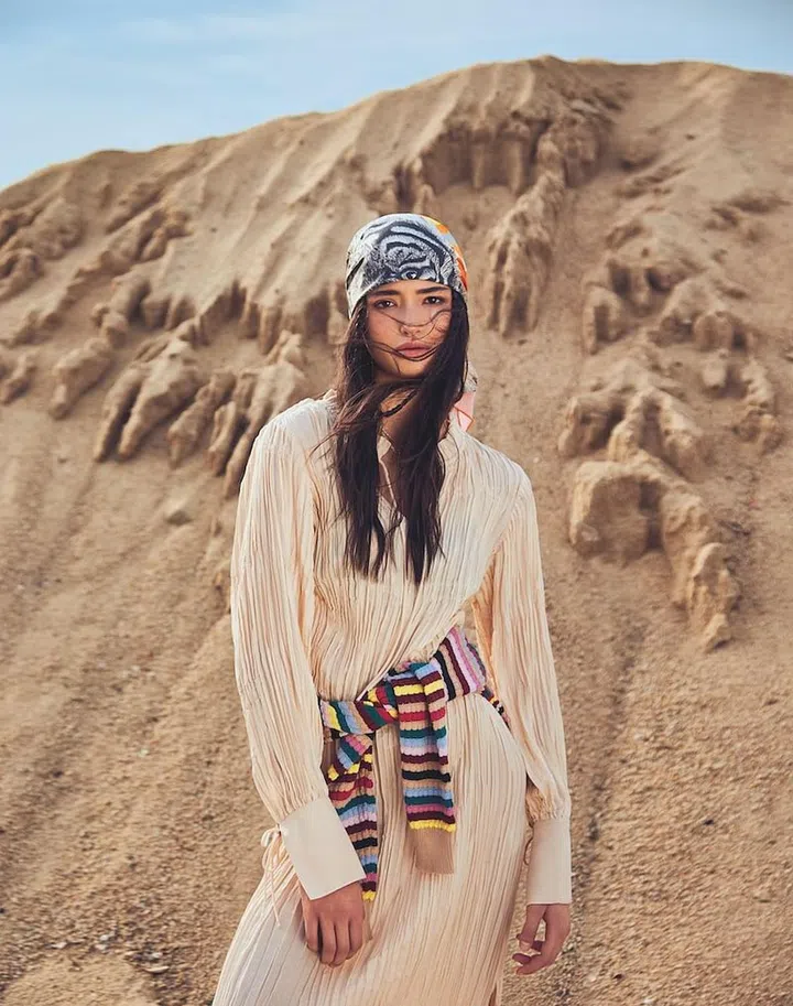 Sweater (tied around waist), Weekend Max Mara. Dress, H&M. Scarf (around head), Hermès. Necklaces, Louis Vuitton. Charm necklace, Dior. Necklace, model’s own. (Photo:  Phyllicia Wang)