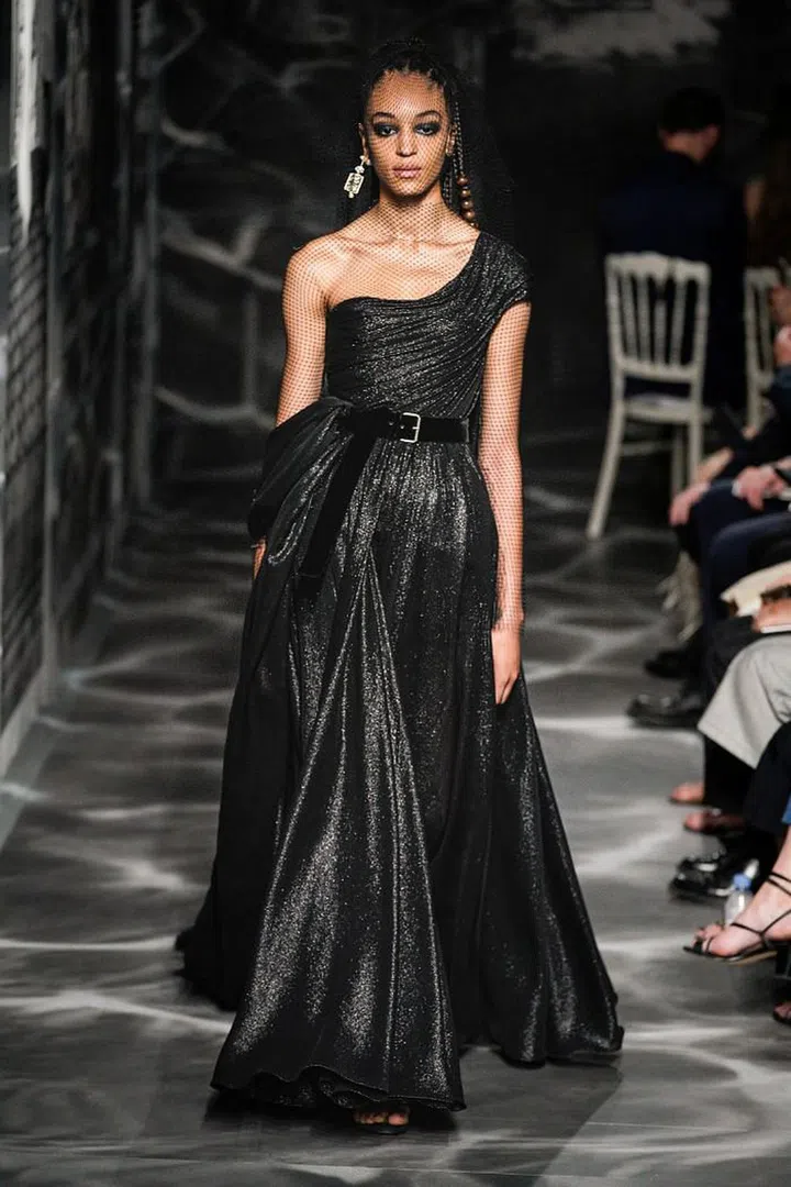 Maria Grazia Chiuri’s starting point was Bernard Rudofsky’s landmark 1944 exhibition at the Museum of Modern Art, “Are Clothes Modern?”, which explored the relationship between people and the garments they wore. The architect’s musings on the form and function of clothing led Chiuri to the idea of fashion as architecture for the body. Her main focus this season was therefore on construction, explored in the myriad ways she draped and sculpted cloth to the human form, which she further veiled and revealed with layers of opaque and sheer fabrics. The collection itself was executed almost entirely in black, allowing cut and silhouette to take centre stage. As Monsieur Dior himself said about the timeless hue: “It is the most fl attering. I could write a book about black.” Taking his words to heart, Chiuri wrote a bewitching new chapter for the House.

Photo: Courtesy