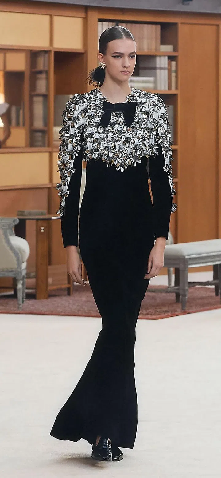 Following in Karl Lagerfeld’s footsteps is no walk in the park. His Chanel has been so successful, it’s tempting to try and replicate his formula; but the Kaiser’s genius is inimitable. Cleverly, Virginie Viard decided to forge her own path ahead. Her stewardship of the storied House thus far has been marked by a refreshing sense of restraint. For her fi rst haute couture outing, she turned the Grand Palais into a colossal library—an impressive spectacle no doubt, but decidedly more down to earth than her predecessor’s extravaganzas. It was a tribute to both Coco Chanel’s book-lined apartment and to Lagerfeld, whose personal book collection reportedly numbered 300,000. The clothes similarly fused both their spirits—the ease and modernity she championed, and the House codes he endlessly reinterpreted. The show opened with slim, elongated lines in the form of ankle-length coats and an emphasis on trousers, worn with fl at shoes and reading glasses. Faces were framed by portrait necklines, satin bibs, organza lapels and ruff  collars. Things gradually shifted into a more ornamental mood, but even the most decorative pieces had an ease to them. An intricately embroidered bandeau, for instance, was off set by a monastic white skirt. For evening, Viard proposed columns of monochrome velvet, lace and pleated silk—harking back to the liberating nonchalance and Modernist lines of Coco Chanel.

Photo: Courtesy