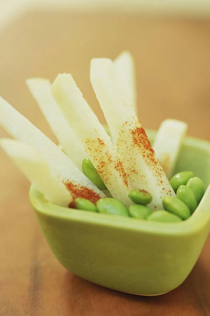 Grown year-round in tropical climates, this crunchy veggie contains a naturally occurring prebiotic that helps your body metabolize B vitamins — a good thing, considering the nutrient helps produce an amino acid that promotes fat metabolism, according to Pomroy, who adds that this superpower can promote a flat belly, healthy bowel movement, and high energy levels. Registered dietitian Dawn Jackson Blatner recommends snacking on jicama sticks dressed with a squeeze of lime and chili powder, which can beat healthy eaters' baby carrot fatigue.