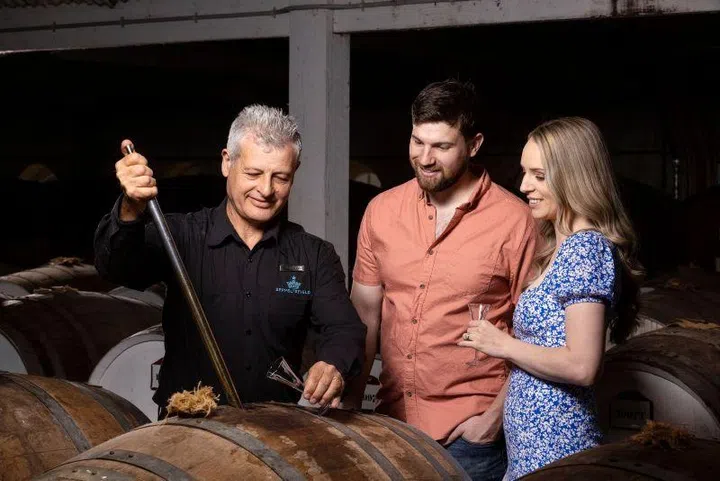 Guests at Seppeltsfield,  enjoying the Centennial Collection experience which offers a rare pour: a century-old tawny drawn straight from the barrel inside a 150-year-old cellar