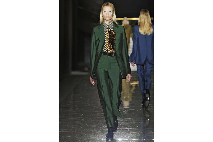 Miuccia Prada's slick silk suits, printed blouses and ties recalled — if not exactly literally — the turquoise, tight bespoke costume from "Life on Mars". ; Photo: Imaxtree