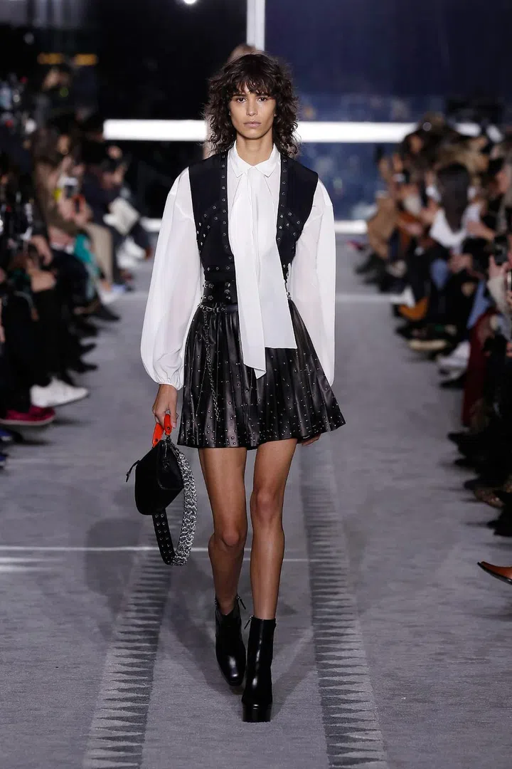 Sophie Delafontaine has always set out to create versatile separates that women can integrate into their existing wardrobes and deploy interchangeably as needed. This season, on a carpeted runway that
evoked the aisles of the legendary Concorde, Delafontaine sent out a collection that spoke of the jet-set and the golden age of travel. Her destination? The high-octane ’80s and the bohemian
’70s. Breezy boho-chic came through in the shaggy faux furs, as well as the pussybow blouses and retro printed dresses cinched with tan leather belts and set atop knee-high boots. On the ’80s
end of the equation were the studded black leathers, flippy miniskirts, small waists paired with big shoulders, leopard bodysuits and the Stephen Sprouse-influenced LGP monogram.