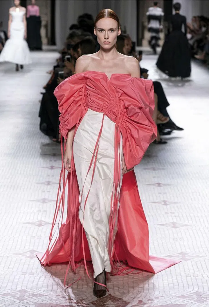 Clare Waight Keller has made refined elegance a cornerstone of her Givenchy haute couture, but this season, she also threw in a hint of rebellion to shake things up. Silhouettes that started rigorously tailored ended in raw-edged fringe or trailing ribbons on the floor. Despite the note of punk she inserted—most prominently in the form of sweeping, spiky updos on some of the models—her default mode was polish. The silhouettes were extravagant, but expertly sculpted; the bursts of feathers and taffeta were all carefully engineered. When she did use colour, it was in the form of opulent texture—silver embroideries, emerald brocade, plumage in coral and mint. It was a masterful balancing act between razzle-dazzle and restraint. 

Photo: Courtesy