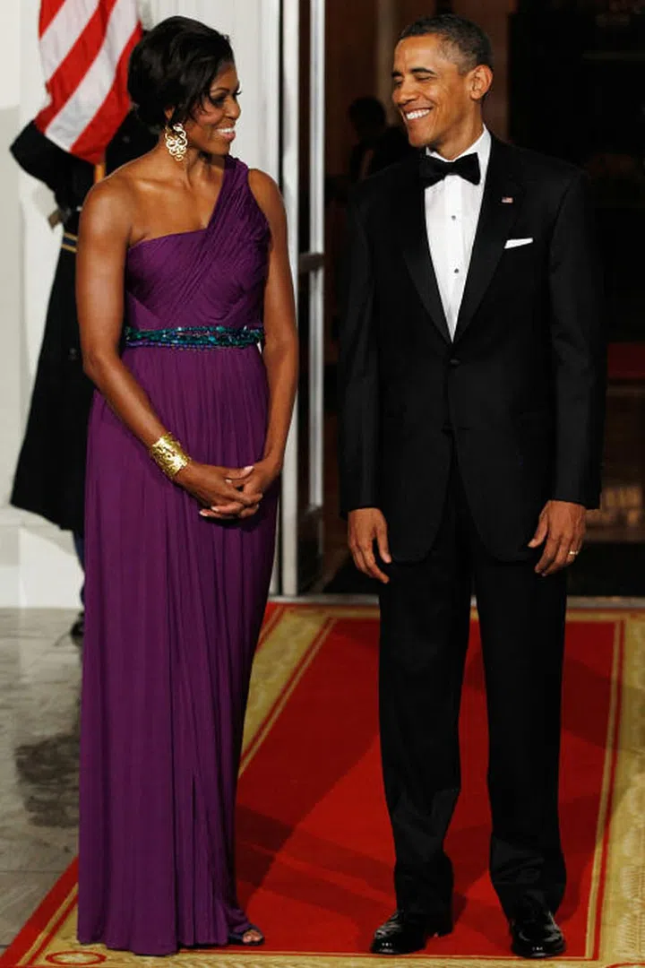 Michelle Obama wears a beautiful purple gown with turquoise beaded waist by Korean-American designer Doo-Ri Chung.