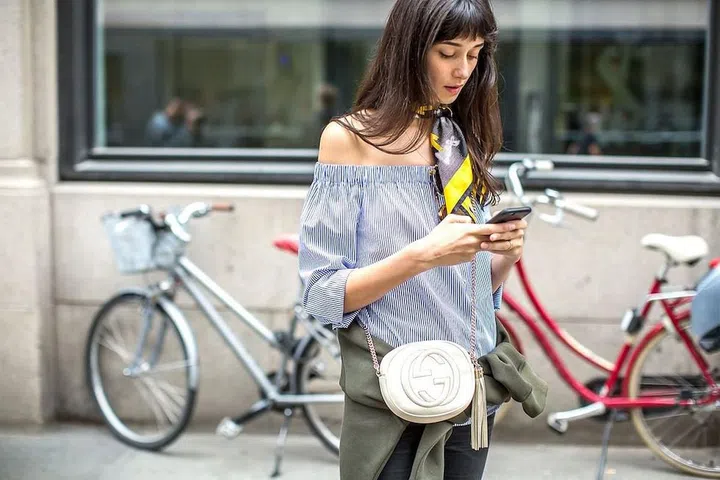 Tie a silk scarf around your neck to add a pop to an off-the-shoulder silhouette.

Photo: Diego Zuko