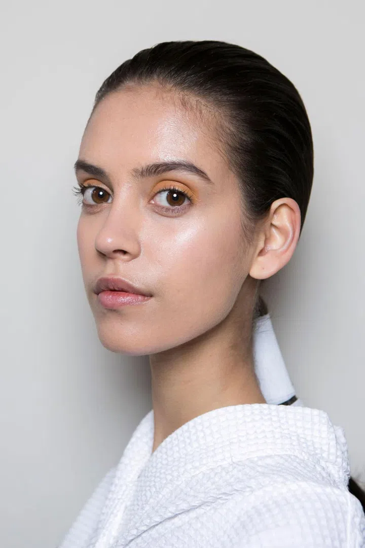 Earthy brown and green tones were used on models' eyes at Victoria Beckham, while their hair was fastened back into low, sleek ponytails.