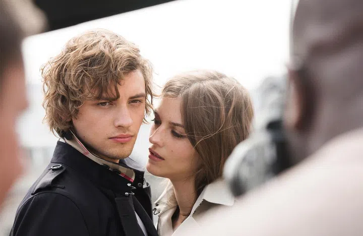Josh Whitehouse and Amber Anderson in front of Steve McQueen’s 70mm film camera lens.