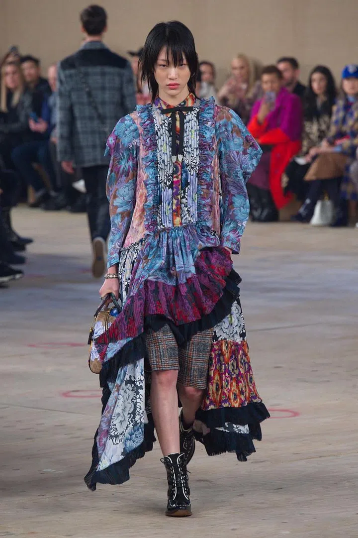 Stuart Vevers built Coach on a rose-tinted view of Americana, establishing signatures like sweeping prairie dresses and pretty, playful prints, but the past few seasons have seen things taking a darker and tougher turn. In line with that mood, the first look out this season was a sleeveless shearling coat worn over boyish basketball shorts. A sharply cut suit followed soon after, along with low-slung trousers and more of those baggy shorts. A collaboration with textile artist Kaffe Fassett—whose trippy prints defined the psychedelic ’70s—yielded
lush painterly florals, which looked smashing on diaphanous layers contrasted against plaids, checks and the brand’s C-logo.