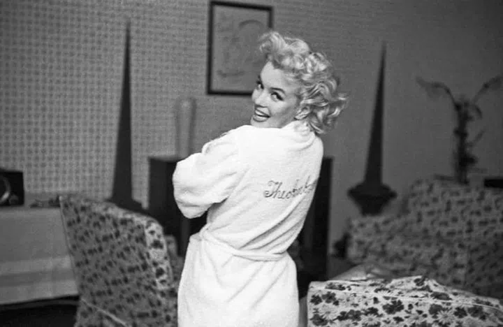 In a terry-cloth robe. 
