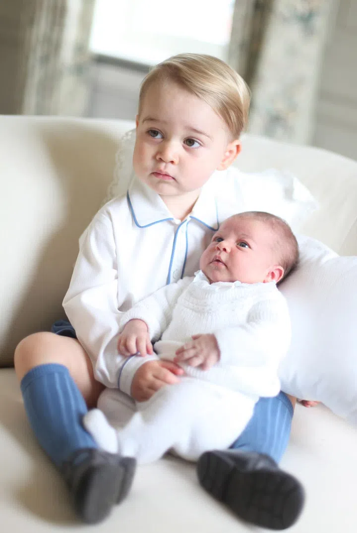 EMBARGOED TO 22:00 BST Saturday June 6. This picture, or pages featuring this picture, must not be tweeted or used on any social media until after 22:00 Saturday.  Copyright: HRH The Duchess of Cambridge 2015. NEWS EDITORIAL USE ONLY. NO COMMERCIAL USE (including any use in merchandising, advertising or any other non-editorial use including, for example, calendars, books and supplements). This photograph is provided to you strictly on condition that you will make no charge for the supply, release or publication of it and that these conditions and restrictions will apply (and that you will pass these on) to any organisation to whom you supply it. All other requests for use should be directed to the Press Office at Kensington Palace in writing.
Undated handout photo released by the Duke and Duchess of Cambridge of Prince George and Princess Charlotte. The photograph was taken by the Duchess in mid-May at Anmer Hall in Norfolk. PRESS ASSOCIATION Photo. Issue date: Saturday June 6, 2015. See PA story ROYAL Baby. Photo credit should read: Duchess of Cambridge.