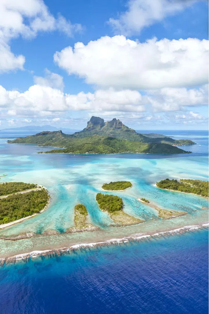 With turquoise lagoons, coral reefs and overwater bungalows, this small island in the South Pacific is basically heaven on Earth. Photo: Getty/Matteo Colombo
