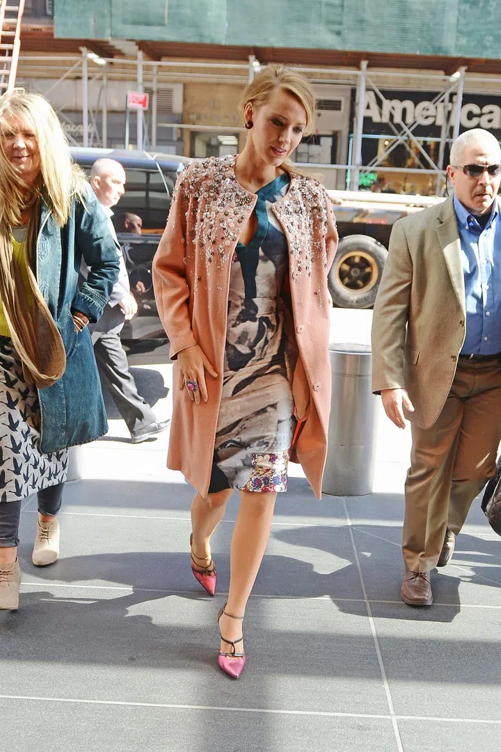 In Jenny Packham fall 2013 embellished coat and Antonio Berardi dress