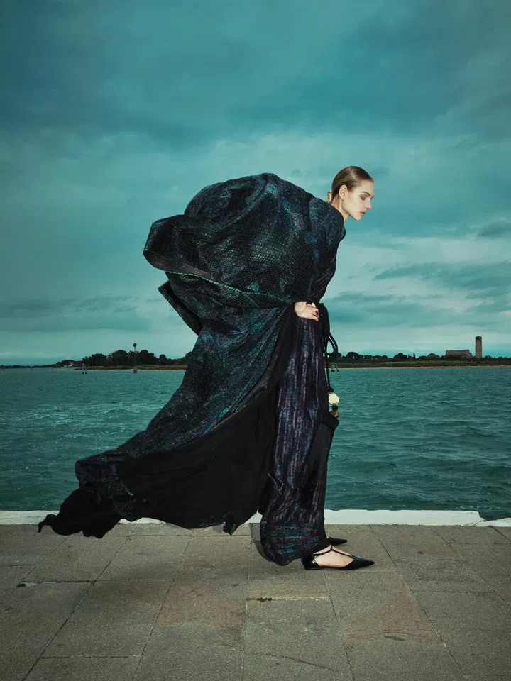 Model wears a robe with tassel in silk and a dress from Max Mara Resort 2025 collection shot in Burano island, Venice
