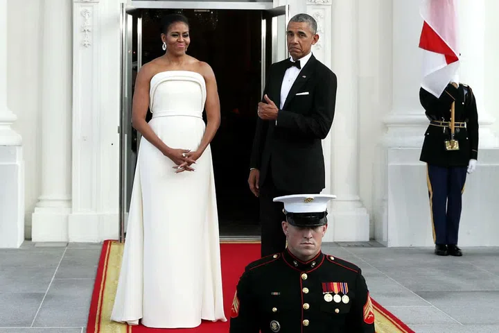 The President gives another thumbs up for his wife's flawless style in this strapless white dress by Brandon Maxwell.