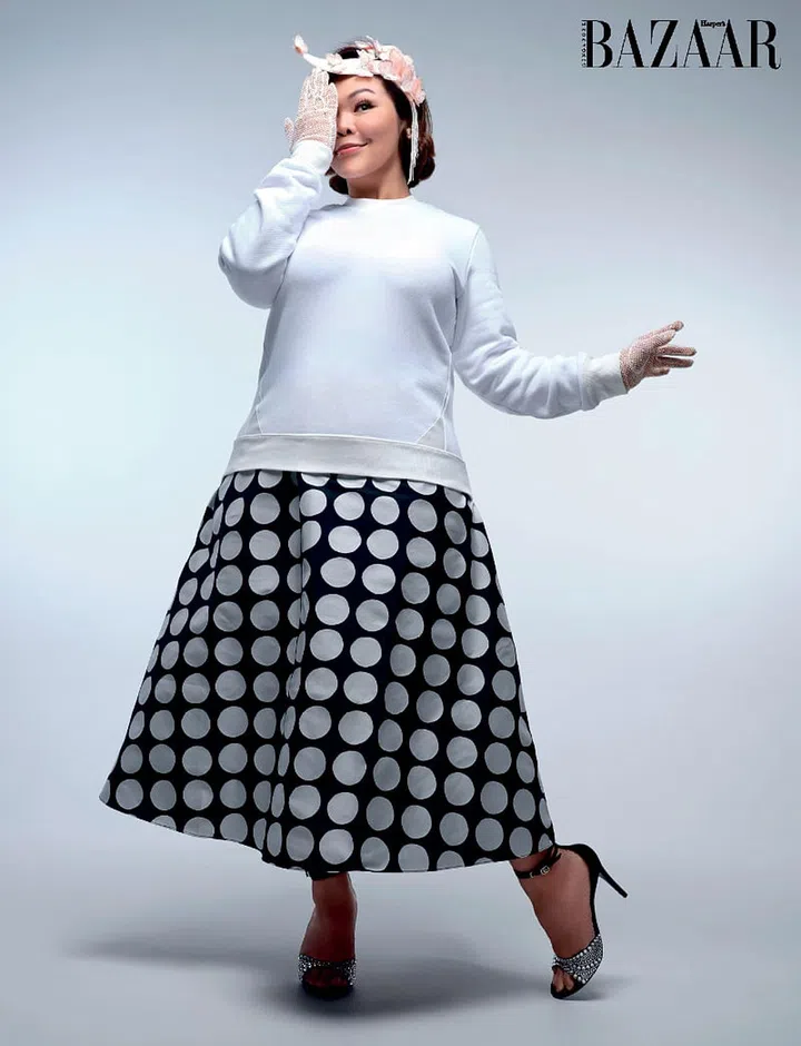 Sweater, Moncler. Skirt, Kate Spade New York. Headband, Eskapade. Sandals, Gucci. Gloves, stylist’s own.