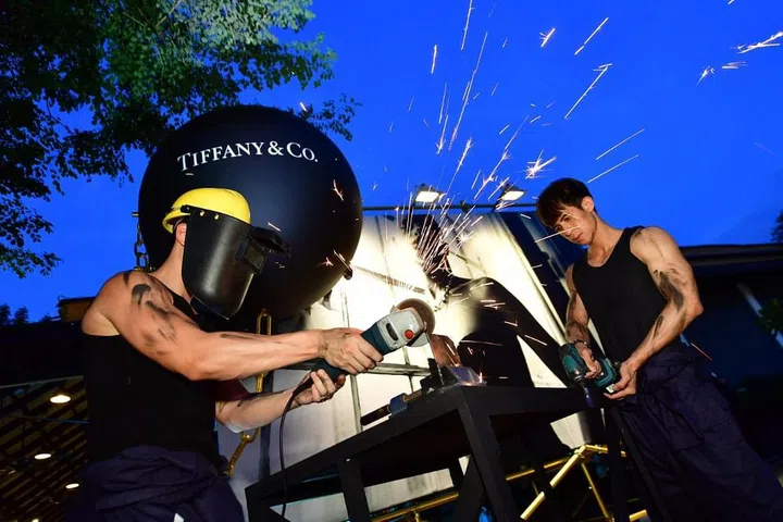 Welders situated at the entrance of the party venue created a spectacle, and photo op, for guests 