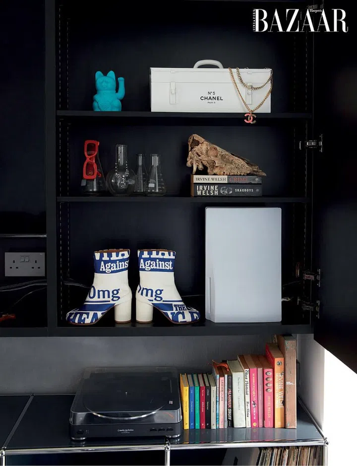 The shelves, on which thriller novels, art books, vinyls, Chanel necklaces, Tory Burch sunglasses and Maison Margiela boots rest, present a snapshot of the couple’s interests.