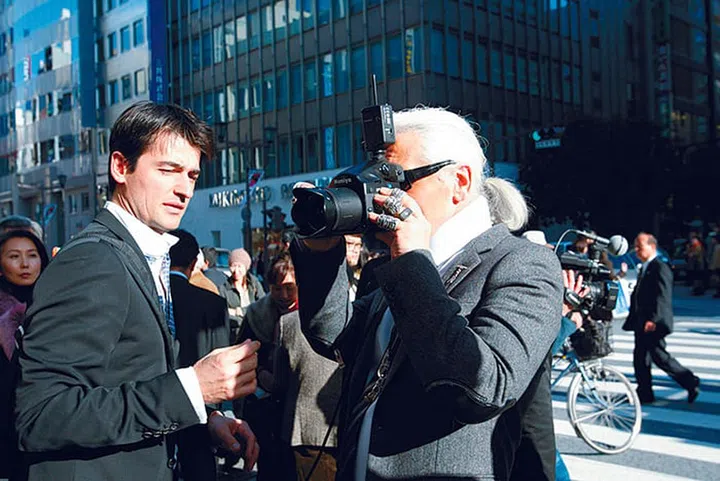 Lagerfeld taking pictures of the models on the streets of Tokyo